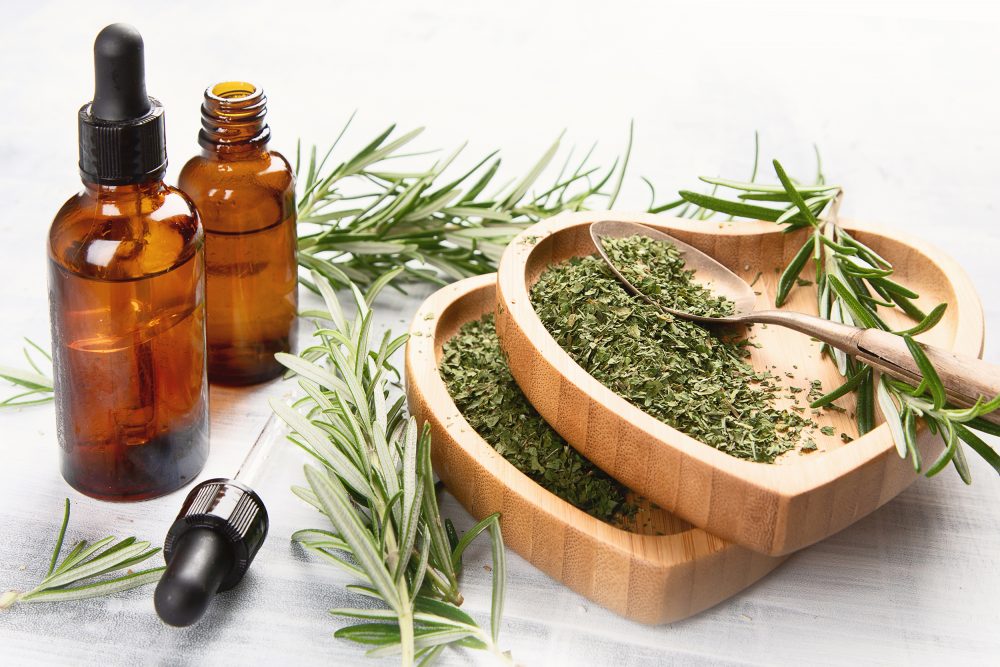 Oils - Hemp leaves and tinctures arranged on table